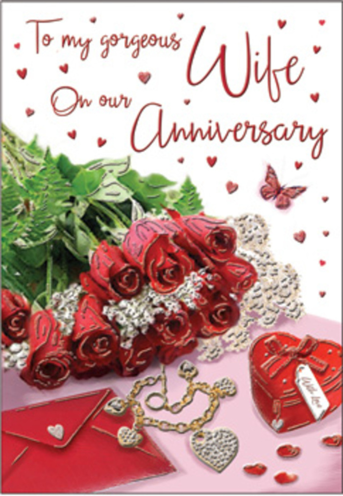 In this richly romantic anniversary image, the foreground is dominated by a classic bouquet of red roses, each bloom fully open and luxuriously rounded, as if just arranged by an experienced South Tottenham florist. The roses are wrapped and gathered with care, their petals a deep, velvety scarlet that suggests warmth, passion, and long-standing devotion. Lush green foliage weaves between the flowers, adding volume and contrast, the leaves catching tiny highlights from the gentle ambient light, much like the subtle shimmer seen through shop windows along Philip Lane on a bright afternoon. Surrounding the bouquet are delicate heart motifs and fine lace-like textures that soften the scene, framing the flowers with a gentle, romantic border. Beside the blooms rests a vivid red box, likely a jewellery case, its smooth surface and tidy edges hinting at a treasured piece inside-perhaps an anniversary necklace or bracelet chosen after much thought. Nearby, a matching jewellery set is laid out, glinting quietly in tones of gold and silver, each piece arranged as though the wearer has just taken them off after an evening celebration. The background remains soft and unobtrusive, with subtle tones that allow the rich reds and greens to stand proudly in the spotlight. A scripted message winds gracefully across the card, its elegant lettering echoing the curves of rose petals and the loops of a handwritten note. Together, the flowers, gifts, and gentle textures create an atmosphere of intimate celebration, as timeless and reassuring as a couple revisiting favourite streets and cafés in South Tottenham year after year.